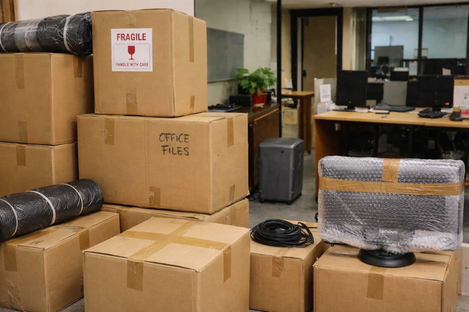 Office moving process with packed office equipment and files ready for transport